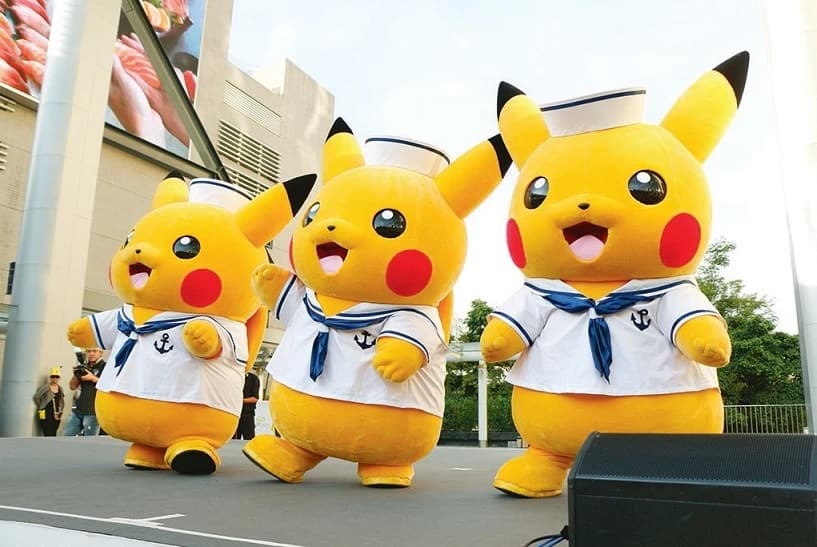 Pikachu mascots in sailor outfits on stage
