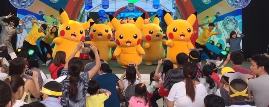 Pikachu mascots dancing for families on stage